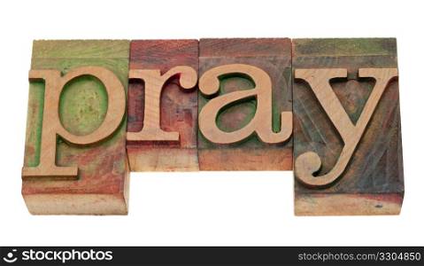 pray word in vintage wooden letterpress printing blocks, stained by color inks, isolated on white