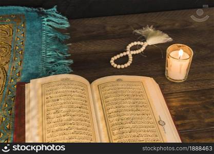 prayer beads candle near religious book . Resolution and high quality beautiful photo. prayer beads candle near religious book . High quality and resolution beautiful photo concept