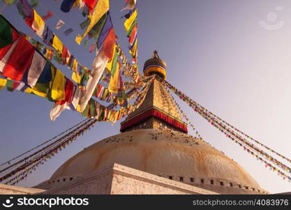 Prayer flags and Boudhanath stupa in Kathmandu. buddhism and religion