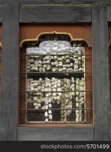 Prayer tags viewed from a window glass, Chokhor Town, Bumthang District, Bhutan