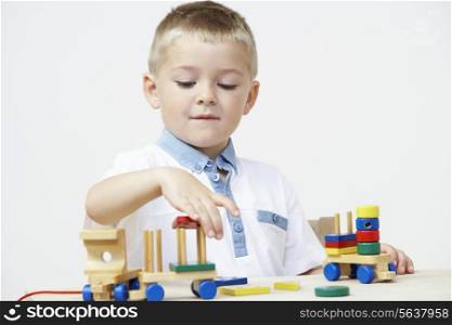 Pre-School Pupil Playing With Wooden Toy Train