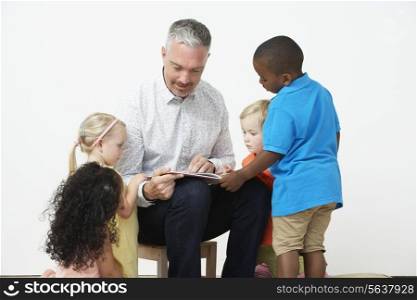 Pre School Teacher Reading Story To Children