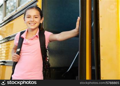 Pre teen girl getting on school bus