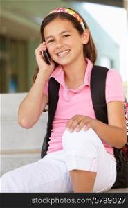 Pre teen girl with phone at school