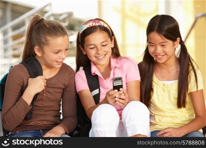 Pre teen girls in school with cellphone