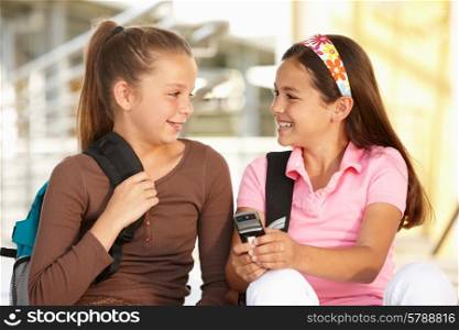 Pre teen girls in school with cellphone