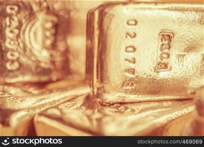 Precious shiny gold bars on color background. Gold ingots for finance and banking concept. Economy trends background for business idea. Trade in precious metals. Close up, Selective focus.. Precious shiny gold bars. Background for finance banking concept. Trade precious metals. Bullions.