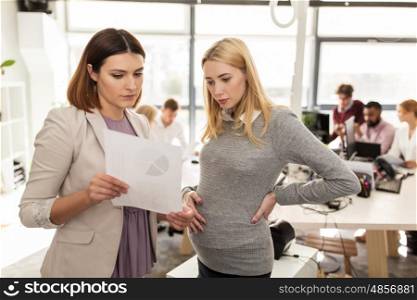 pregnancy and people concept - business team with papers in office. business team with papers in office