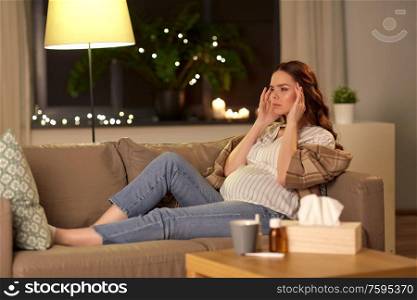 pregnancy and people concept - sick pregnant woman having headache at home. sick pregnant woman having headache at home