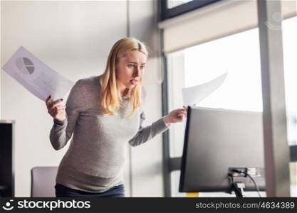 pregnancy, business, stress, people and work concept - angry pregnant businesswoman with papers and computer at office