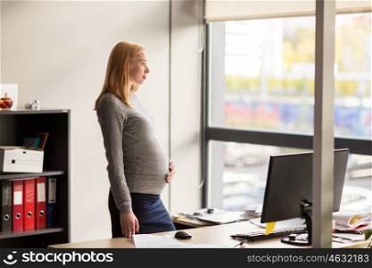 pregnancy, business, work and people concept - pregnant businesswoman looking through window at office. pregnant businesswoman with computer at office