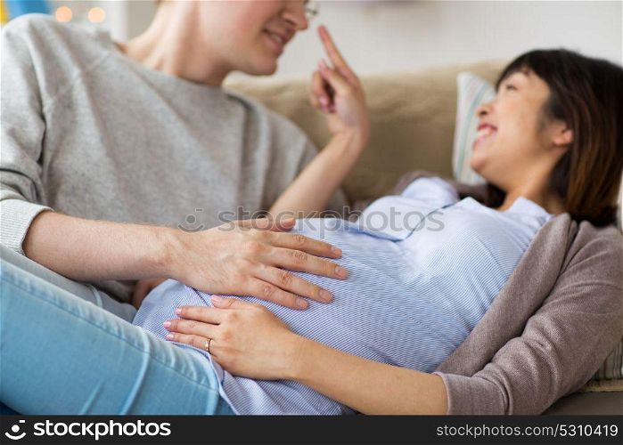 pregnancy, family and people concept - close up of man and pregnant woman. close up of man and pregnant woman