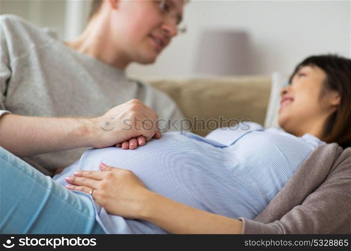 pregnancy, family and people concept - close up of man and pregnant woman. close up of man and pregnant woman