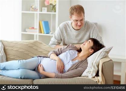 pregnancy, family and people concept - happy pregnant wife with husband at home. happy pregnant wife with husband at home