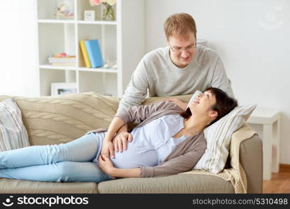 pregnancy, family and people concept - happy pregnant wife with husband at home. happy pregnant wife with husband at home