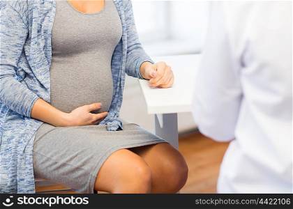 pregnancy, gynecology, medicine, health care and people concept - close up of pregnant woman and gynecologist doctor meeting at hospital