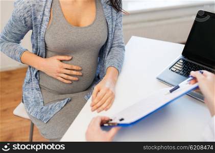 pregnancy, gynecology, medicine, health care and people concept - close up of gynecologist doctor with clipboard and pregnant woman meeting at hospital