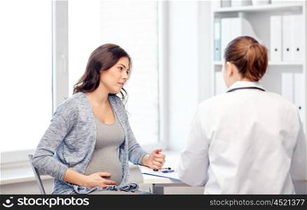 pregnancy, gynecology, medicine, health care and people concept - gynecologist doctor with clipboard and pregnant woman meeting at hospital