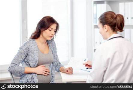 pregnancy, gynecology, medicine, health care and people concept - gynecologist doctor with prescription and pregnant woman meeting at hospital
