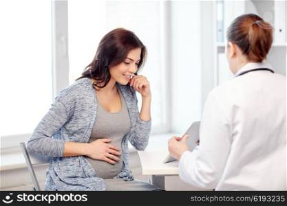 pregnancy, gynecology, medicine, health care and people concept - gynecologist doctor with tablet pc computer and pregnant woman meeting at hospital