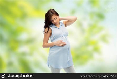 pregnancy, health, people and expectation concept - pregnant woman touching her neck and suffering from ache over green natural background