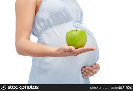 pregnancy, healthy eating, food and people concept - close up of pregnant woman holding green apple over white background