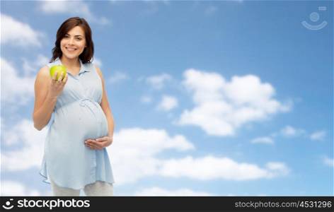 pregnancy, healthy eating, food and people concept - happy pregnant woman holding green apple over blue sky and clouds background