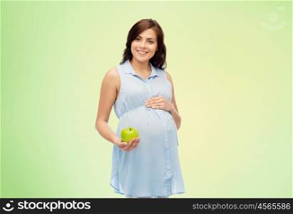 pregnancy, healthy eating, food and people concept - happy pregnant woman holding green apple over green natural background