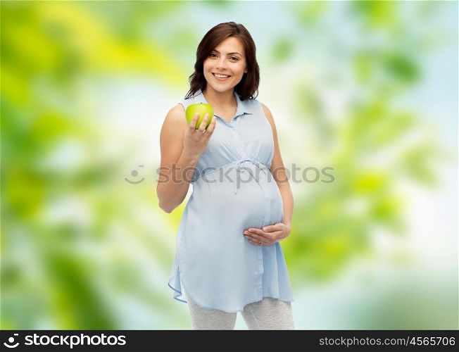 pregnancy, healthy eating, food and people concept - happy pregnant woman holding green apple over green natural background