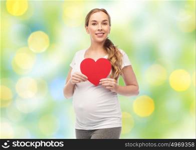 pregnancy, love, people and expectation concept - happy pregnant woman with red heart over summer green lights background. happy pregnant woman with red heart
