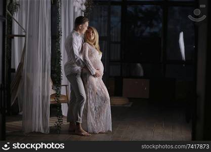 pregnancy man woman home comfort / concept of pregnancy childbirth, big belly, family, love and care