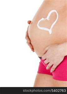 pregnancy, maternity and health concept - belly of a pregnant woman with cream and heart symbol