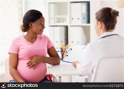 pregnancy, medicine, healthcare and people concept - cardiologist doctor showing cardiogram to pregnant african american woman meeting at hospital. cardiologist and pregnant woman at hospital