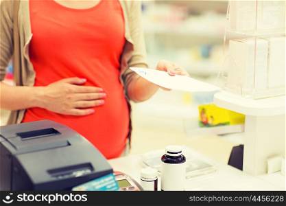 pregnancy, medicine, pharmaceutics, health care and people concept - close up of pregnant woman with prescription buying medication at pharmacy cash register