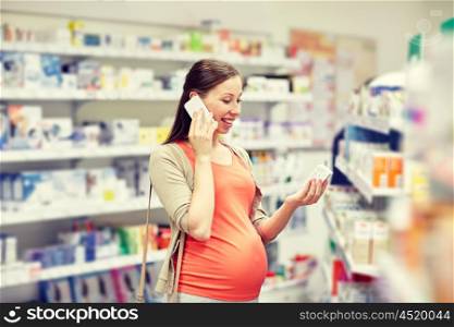 pregnancy, medicine, pharmaceutics, health care and people concept - happy pregnant woman calling on smartphone and choosing medication at pharmacy