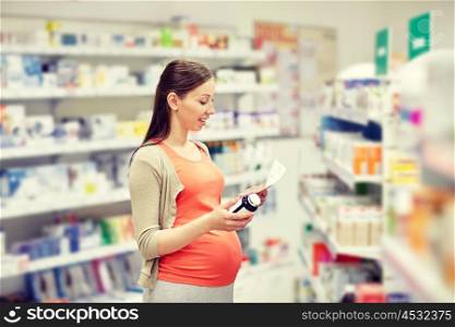 pregnancy, medicine, pharmaceutics, health care and people concept - happy pregnant woman with medication reading prescription paper at pharmacy