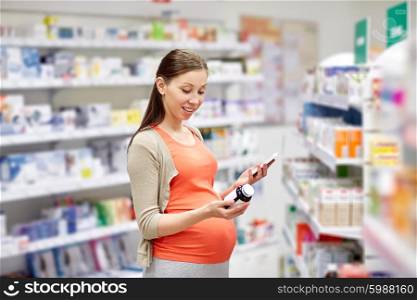 pregnancy, medicine, pharmaceutics, health care and people concept - happy pregnant woman with smartphone choosing medication at pharmacy