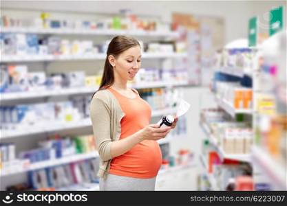 pregnancy, medicine, pharmaceutics, health care and people concept - happy pregnant woman with medication and prescription paper at pharmacy