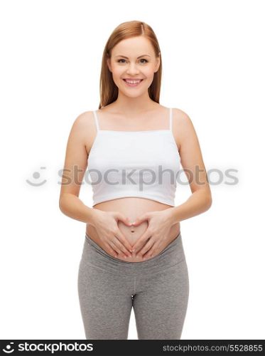 pregnancy, motherhood and happiness concept - happy future mother showing heart with her hands