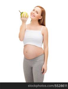 pregnancy, motherhood and happiness concept - happy future mother with green apple
