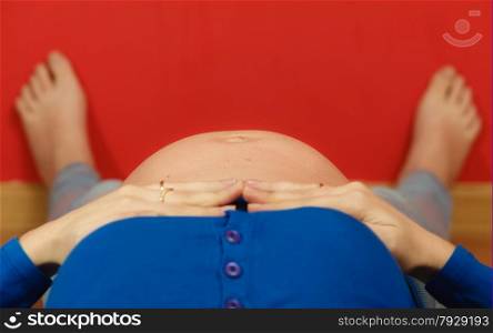Pregnancy, motherhood and happiness concept. Pregnant woman lying on floor relaxing