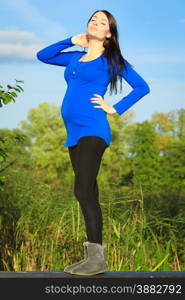 Pregnancy, motherhood and happiness concept. young happy pregnant woman walking relaxing and enjoying life in nature