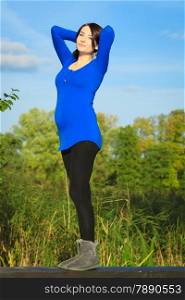 Pregnancy, motherhood and happiness concept. young happy pregnant woman walking relaxing and enjoying life in nature