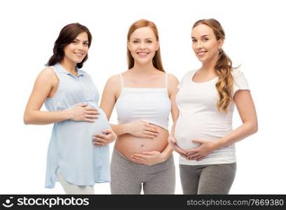 pregnancy, motherhood and people concept - happy smiling pregnant women touching their big bellies over white background. happy pregnant women touching their big bellies