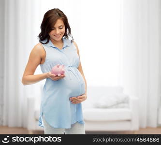 pregnancy, motherhood, finance, saving and people concept - happy pregnant woman with piggybank over home room background