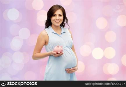 pregnancy, motherhood, finance, saving and people concept - happy pregnant woman with piggybank over rose quartz and serenity holidays lights background