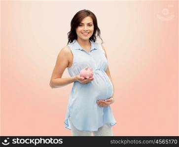 pregnancy, motherhood, finance, saving and people concept - happy pregnant woman with piggybank over beige background