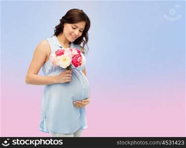 pregnancy, motherhood, holidays, people and expectation concept - happy pregnant woman with flowers touching her big belly over rose quartz and serenity gradient background