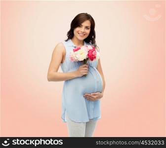 pregnancy, motherhood, holidays, people and expectation concept - happy pregnant woman with flowers touching her big belly over beige background