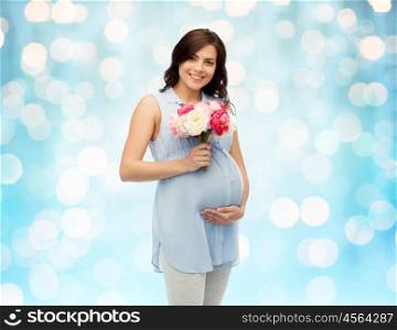 pregnancy, motherhood, holidays, people and expectation concept - happy pregnant woman with flowers touching her big belly over blue holidays lights background